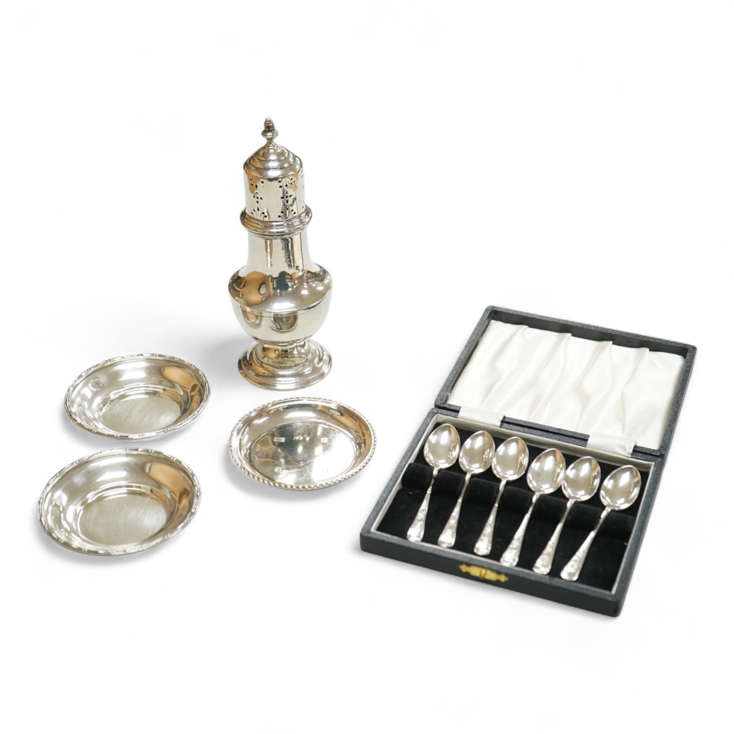 A George V silver sugar caster by Walker & Hall London 1932, 16cm, together with three silver nut dishes and a cased set of six silver coffee spoons.